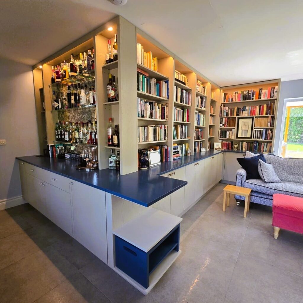 Integrated home bar with display shelving and a blue counter in Kildare