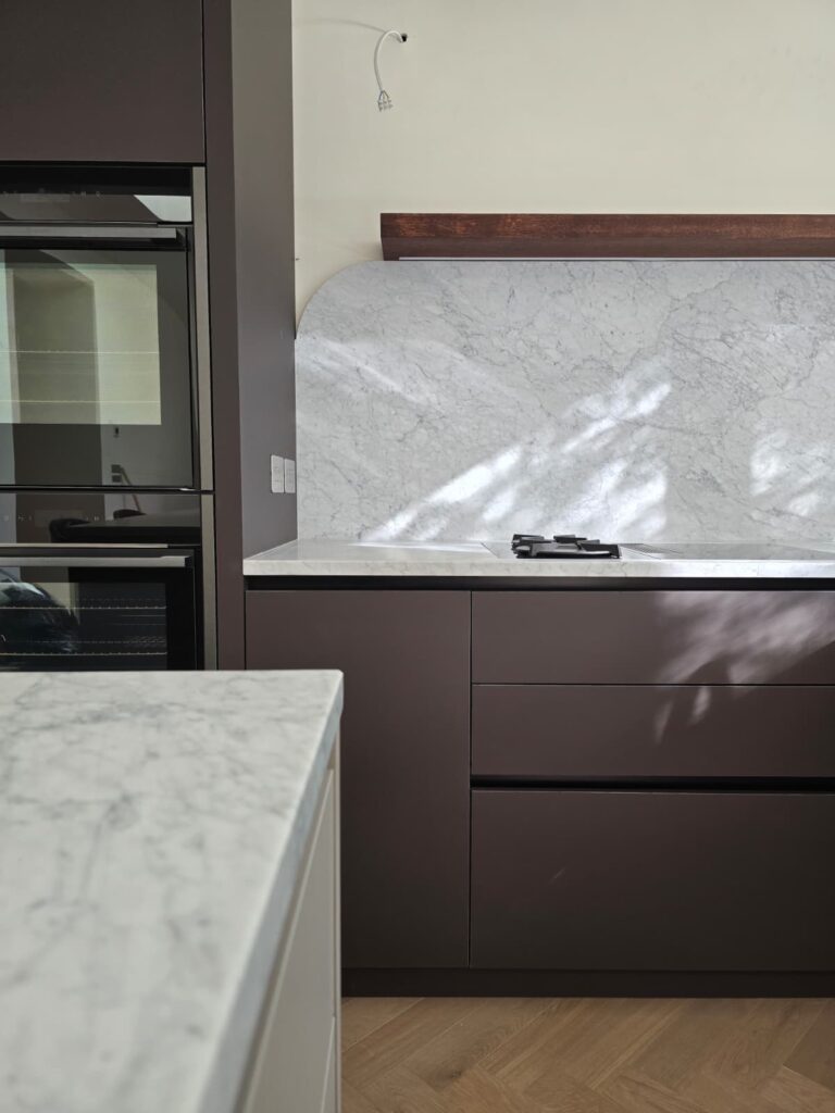 Dublin 4 bespoke kitchen: cabinetry and veined splashback