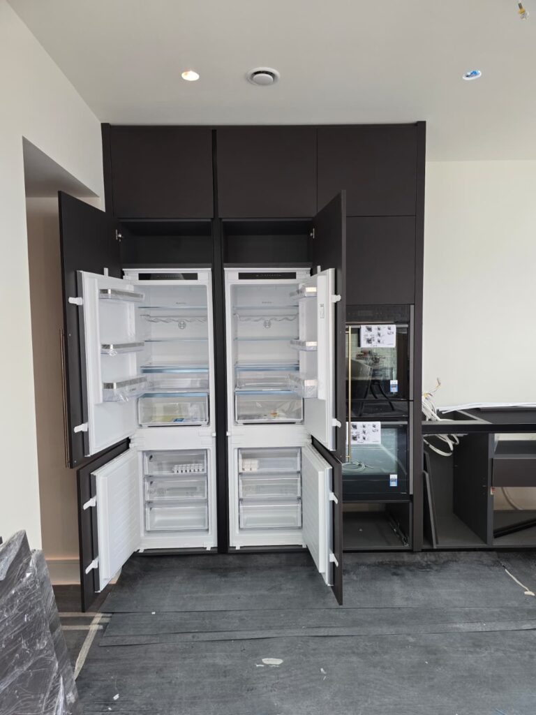 Integrated fridge and freezer within bespoke dark kitchen cabinetry in Dublin 4