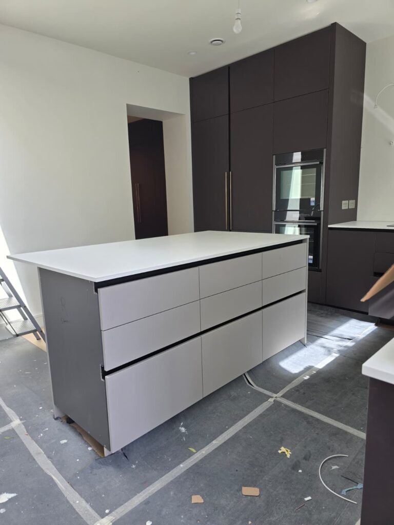 Kitchen island and dark cabinetry during installation in Dublin 4