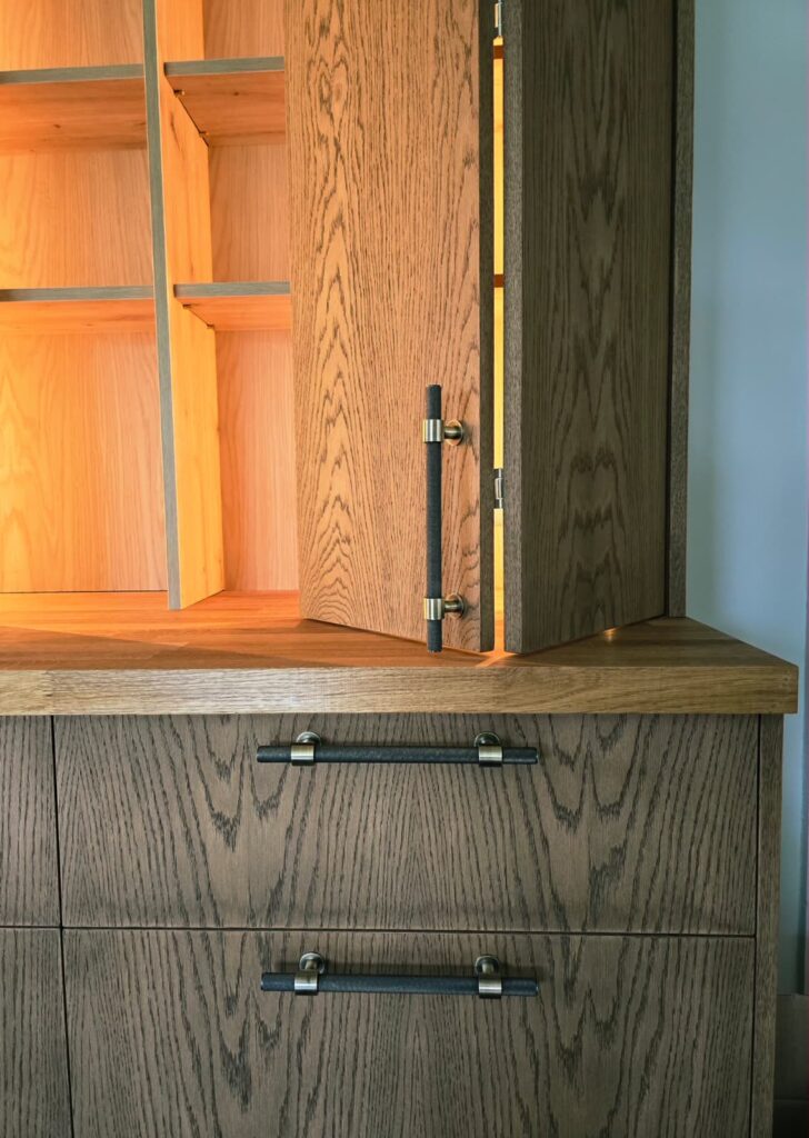 Handmade oak-veneered unit with dark Jacobean finish in Trim, Co. Meath: illuminated cabinet detail