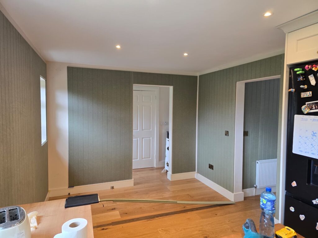 Vertical wall panels being fitted around door openings in Kells